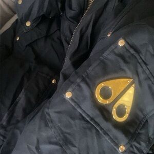 Moose Knuckles Black Puffer Jacket with Gold Details